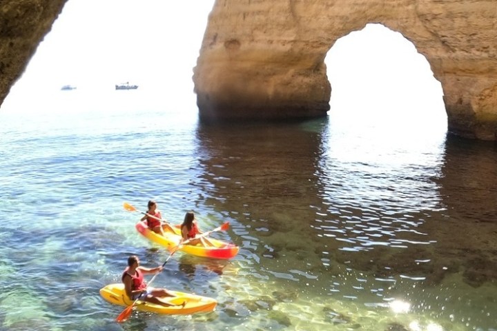 a person sitting on a rock next to a body of water
