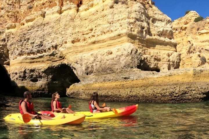 a small boat in a body of water with a mountain in the background