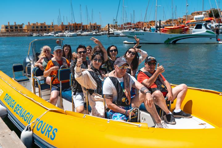 a group of people in a boat on a body of water