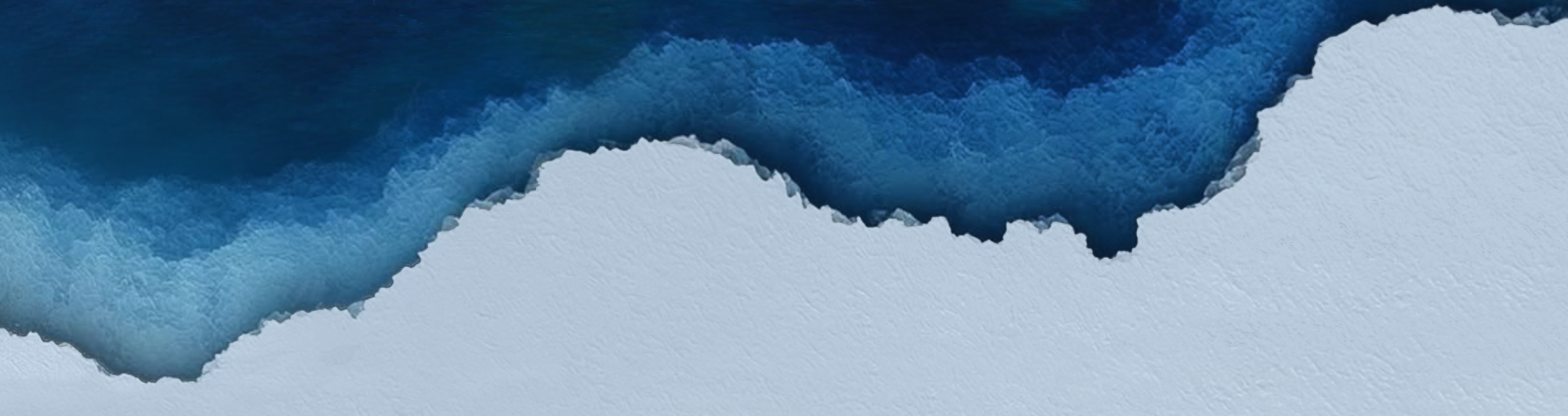 Abstract ocean waves meeting white shore from above.